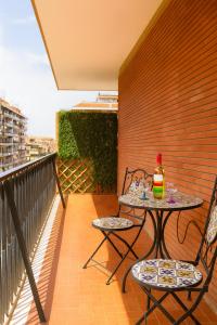 a table and two chairs on a balcony at Bed Cinecitta’ in Rome