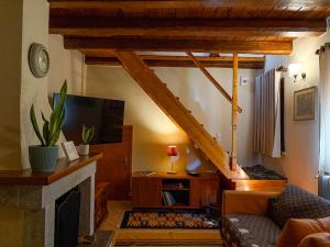 a living room with a couch and a fireplace at to spitaki in Arachova