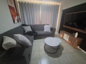 a living room with a couch and a table at Bliss Ballito Apartment in Ballito