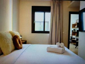 a bedroom with a bed with two towels on it at Top Appartment Cozy in Ersigen