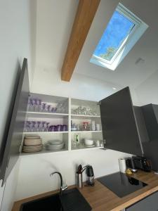 a kitchen with a sink and a window at Maison en Provence avec terrasse privée - Fibre TV in Lambesc +6 photos