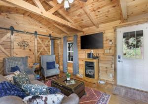 a living room with a fireplace and a tv at Copperhead Cabin- Hocking Hills Hot Tub Games in Logan