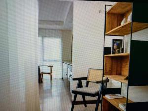 a living room with a chair and a table at Top Appartment Cozy in Ersigen