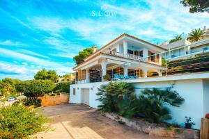 a white house with a balcony on a street at Villa Monsita by Slow Villas in Santa Ponsa