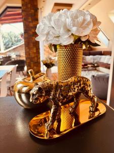 a statue of a dog on a plate on a table at Spa Residence beltéri jakuzzi inside jakuzzi in Veszprémfajsz +28 photos