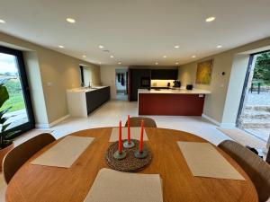 a dining room with a table and a kitchen at Reddaway Byre- brand new conversion in Okehampton