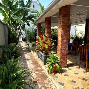 a patio with a bunch of plants on a house at MD Apartments in Arusha