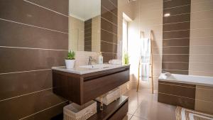 un baño con lavabo y bañera en Homebyvi, en Quarteira 57 fotos más