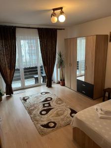 a living room with a rug on the floor at Avantgarden 3 Brasov by BuySellRent in Braşov