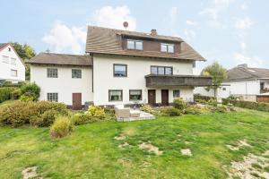 a large white house with a yard at Ferienwohnung Fischer in Heringhausen