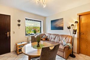 a living room with a couch and a table at Ferienwohnung Fischer in Heringhausen