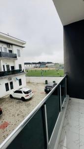 two cars parked on a balcony of a building at Rondawel Luxury 2 Bedroom Apartment, Lekki VGC in Lekki