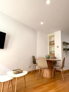 a living room with a table and chairs at The Zentral Suites & Apartments in Seville