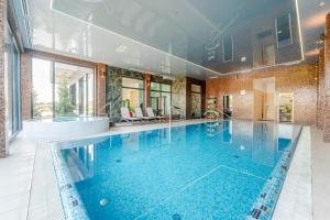 a large swimming pool in a house at Family Resort Sarbinowo in Sarbinowo