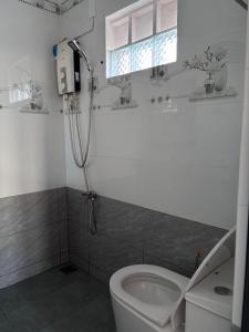 ein Badezimmer mit Dusche und Toilette in der Unterkunft Nhà Nghỉ Đăng Khoa in Ấp Thiện Sơn + 12 Fotos