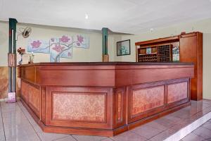 a large wooden bar in a room at Hotel O 90596 Hotel Griya Astoeti in Bogor