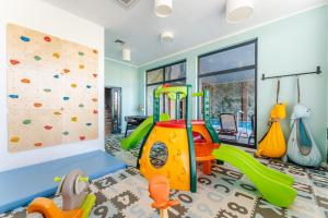 a kids play room with a climbing wall and a climbing gym at Family Resort Sarbinowo in Sarbinowo