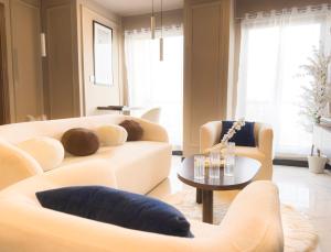 a living room with two couches and a table at The Marrakesh Suites - Skyline ApartHotel In Bahria Town in Rawalpindi