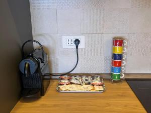 a table with a tray of hot dogs and a phone at BaseFCO - Vicino Aeroporto e Mare in Isola Sacra +4 photos