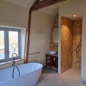 a bathroom with a large tub and a sink at Boetiekhotel Het Gezellenhuis in Ouderkerk aan de Amstel