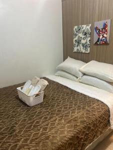 a bed with a box of towels on it at Shore 2 Residences - The Grand Haven in Manila