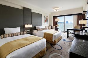Postel nebo postele na pokoji v ubytování Grand Prince Hotel Shin Takanawa