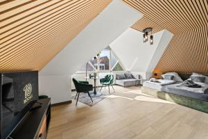 a living room with two beds and a tv at 10 Rooms City Apartments in Emden