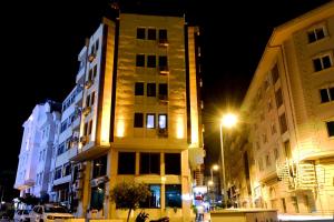 a tall building on a city street at night at Hotel Öncü in Istanbul