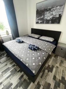 a bedroom with a bed with two clothes on it at City Apartment in Osnabrück