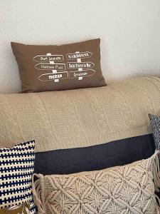a pillow sitting on top of a bed at Duplex plage des chalets Gruissan plage in Gruissan