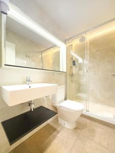 a bathroom with a sink and a toilet and a shower at Ópera Stays by Charming in Madrid