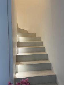 a staircase in a room with a stair case at Villamelina in Puteaux +2 photos