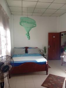 a bedroom with a bed with a green ceiling at Green House No 02 in Galle