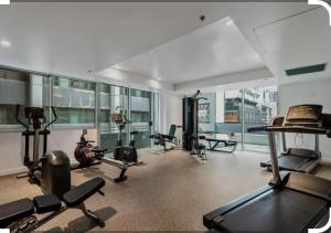 a gym with several exercise equipment in a building at Melborne Collins Home in Melbourne