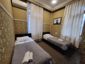 a bedroom with two beds and a window at GuestHouse Old Avlabari in Tbilisi City +38 photos