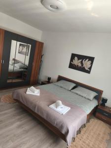 a bedroom with a bed with two towels on it at Apartman Relax in Slavonski Brod