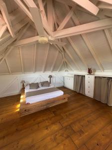 a bedroom with a large bed in a attic at Villa malaurelia in Saint-François