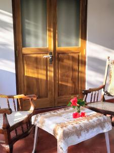 a wooden door with a table and two chairs at Sunee'S Home Stay in Ahangama