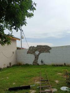 a wall with a bear art on the side of it at whispering roots resort in Jim Corbett
