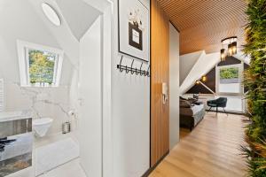 a hallway of a house with a bathroom and a bedroom at 10 Rooms City Apartments in Emden +28 photos