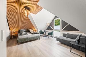 a living room with a bed and a couch at 10 Rooms City Apartments in Emden