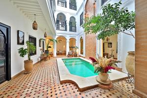 an indoor pool in a house with plants at Riad Dar Beldia and Spa in Marrakech