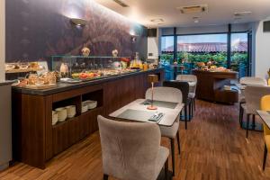 a restaurant with a buffet with tables and chairs at Hotel Mrak in Ljubljana +128 photos