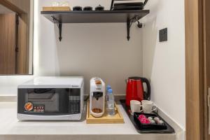 a kitchen counter with a microwave on a counter top at A beautiful one BR apartment with a living room in Al Madinah