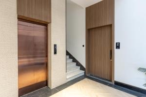 a hallway with two doors and a staircase at A beautiful one BR apartment with a living room in Al Madinah +1 photo