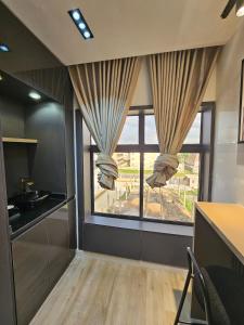 a kitchen with a large window with a view at Sapphire Suite in Abuja