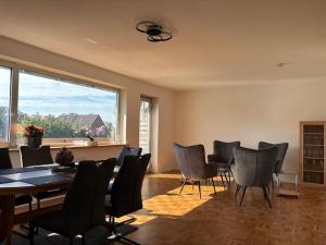 a dining room with a table and chairs and a large window at Unter einem Dach 5 in Lehrte