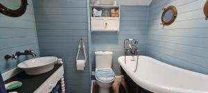 a bathroom with a toilet and a sink and a tub at Charming cottage in Pilton-newly renovated in Barnstaple +24 photos