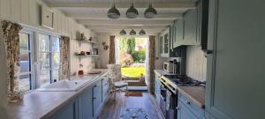 a kitchen with a sink and a stove top oven at Charming cottage in Pilton-newly renovated in Barnstaple