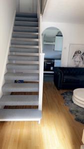 a staircase in a living room with a couch at Home in Colchester in Colchester